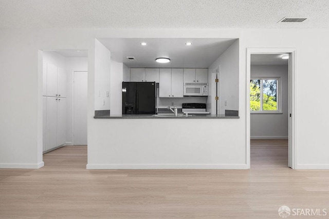 521 Ridgeview Ct, Pleasant Hill, CA 94523 - kitchen with white microwave, black refrigerator with ice dispenser, stove, wood finished floors, and dark countertops