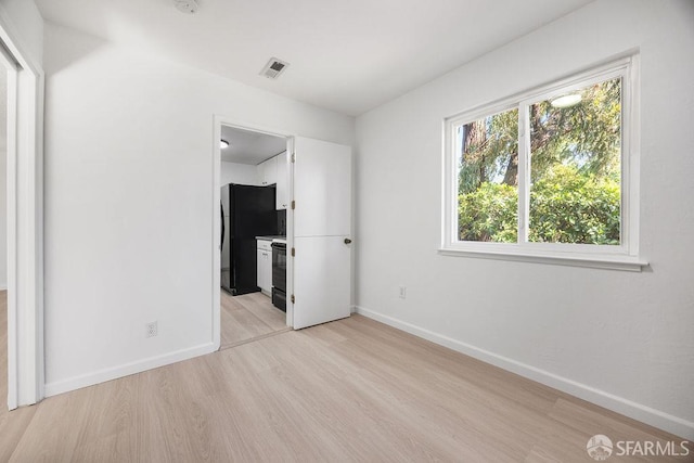 521 Ridgeview Ct, Pleasant Hill, CA 94523 - unfurnished bedroom with freestanding refrigerator, light wood-style flooring, baseboards, and connected bathroom