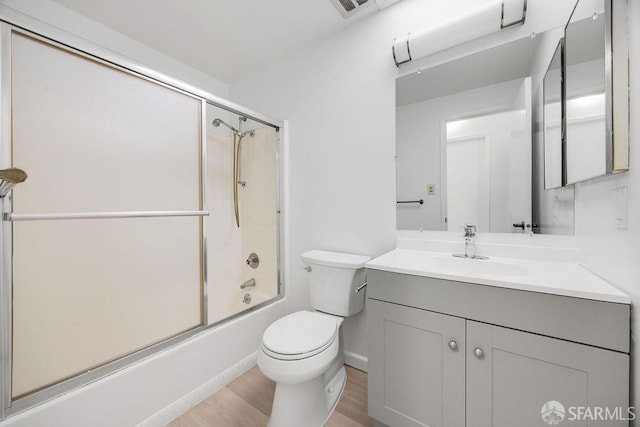 521 Ridgeview Ct, Pleasant Hill, CA 94523 - full bathroom with vanity, toilet, wood finished floors, bath / shower combo with glass door, and baseboards