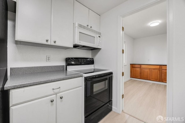 521 Ridgeview Ct, Pleasant Hill, CA 94523 - kitchen with black electric range, white microwave, light wood-style flooring, and white cabinets