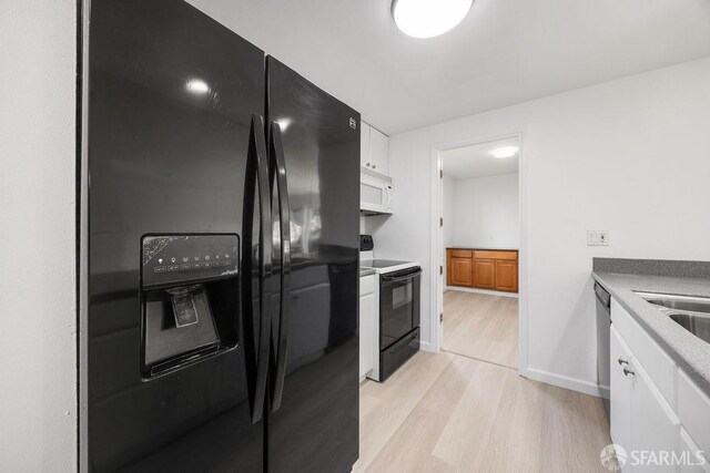 521 Ridgeview Ct, Pleasant Hill, CA 94523 - kitchen with black appliances, light wood-style flooring, white cabinetry, and baseboards