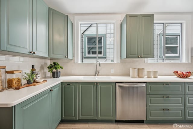 1371 16th Ave Unit 1373, San Francisco, CA 94122 - kitchen with stainless steel dishwasher, green cabinetry, and decorative backsplash