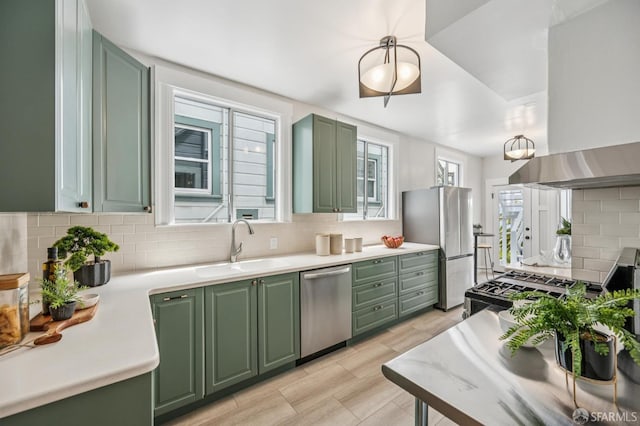 1371 16th Ave Unit 1373, San Francisco, CA 94122 - kitchen with green cabinets, stainless steel appliances, extractor fan, decorative backsplash, and light countertops