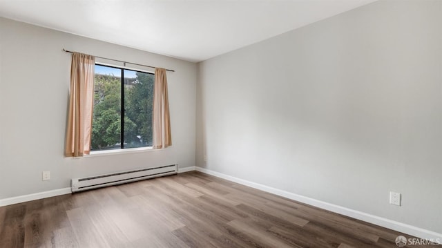 empty room with light wood-type flooring and baseboard heating