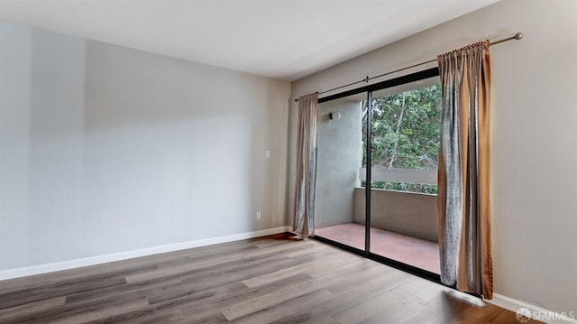 unfurnished room featuring hardwood / wood-style flooring