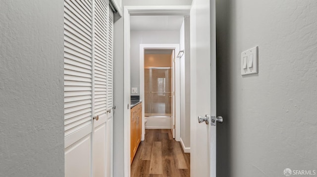 hallway with hardwood / wood-style floors