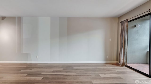 unfurnished room with light hardwood / wood-style floors