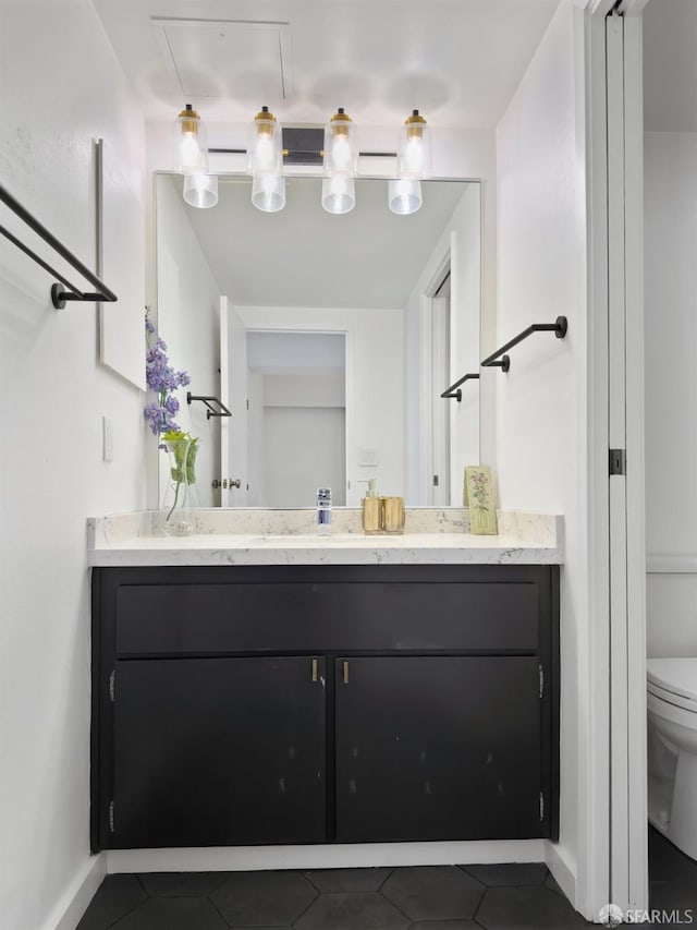 bathroom featuring tile patterned floors, toilet, and vanity