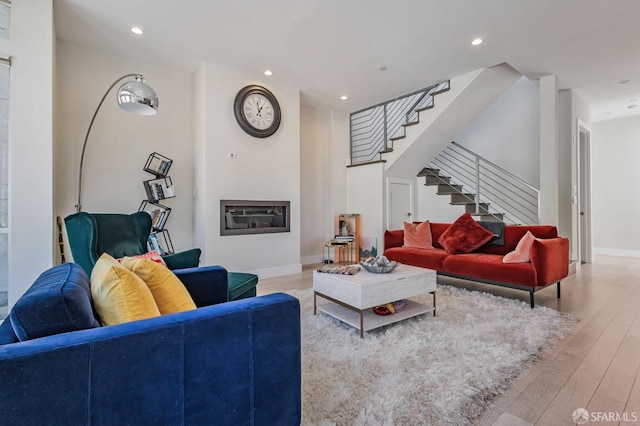 989 Sutter St Unit 2, San Francisco, CA 94109 - living area with stairs, wood finished floors, recessed lighting, a glass covered fireplace, and baseboards