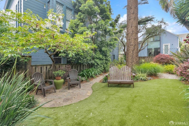 view of yard with fence and a patio