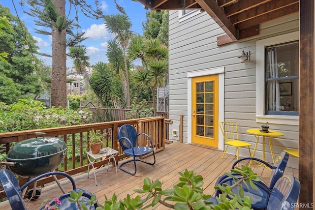 wooden deck with grilling area and fence