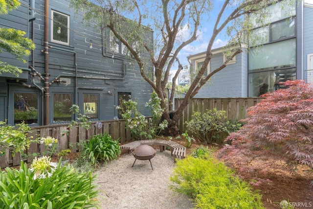 view of yard featuring a fire pit and fence