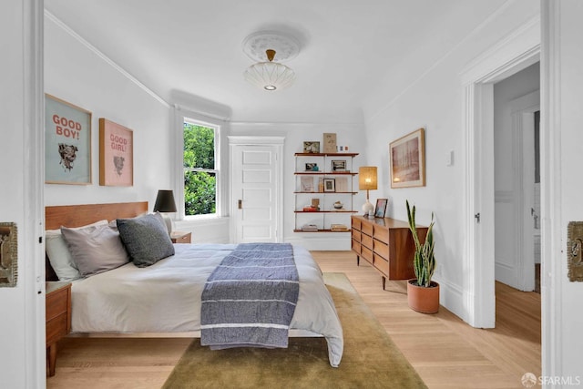 bedroom featuring light wood-style flooring and baseboards