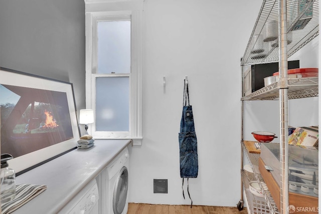 laundry room featuring laundry area, wood finished floors, and washer / clothes dryer