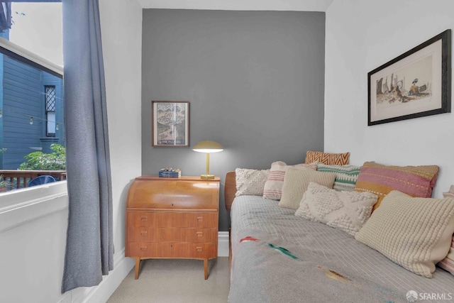 bedroom with carpet flooring and baseboards