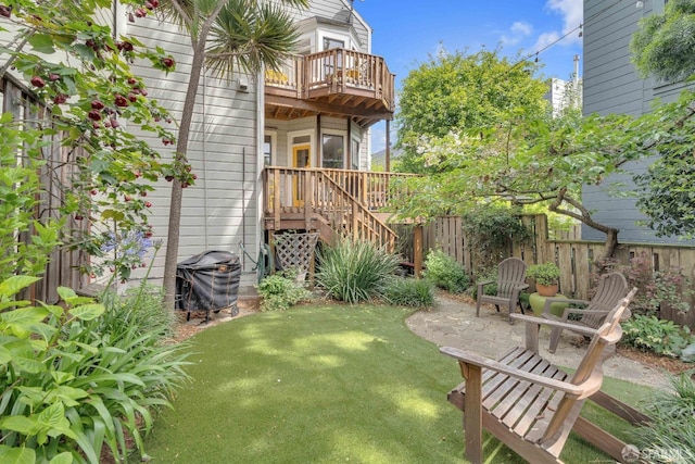 view of yard featuring stairs, fence, central AC unit, and a balcony