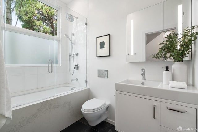 full bathroom with vanity, tile patterned floors, shower / bath combination with glass door, and toilet