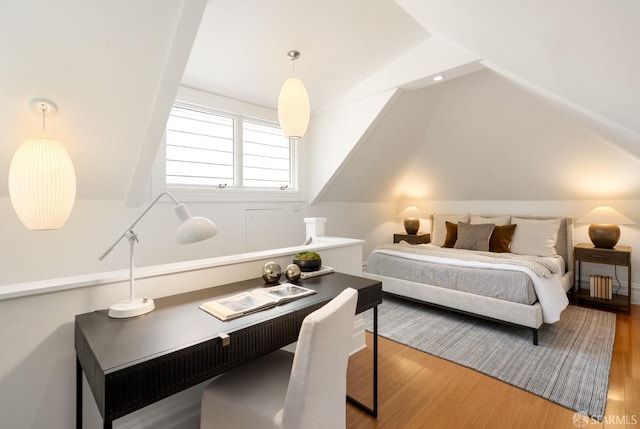 bedroom featuring hardwood / wood-style flooring and vaulted ceiling