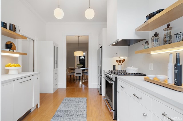 kitchen featuring stainless steel appliances, decorative light fixtures, and white cabinets