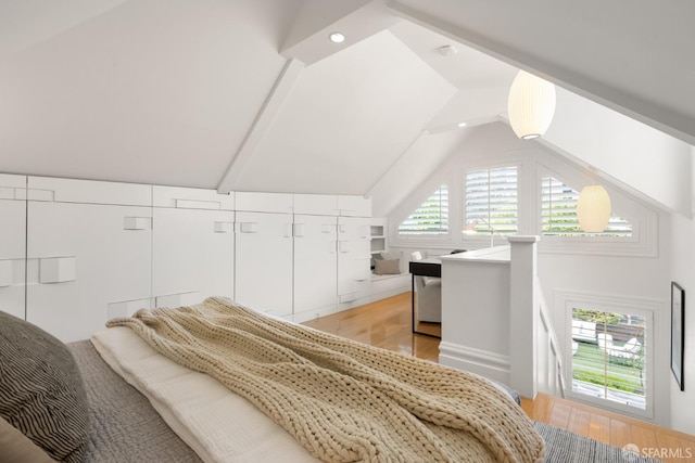 bedroom featuring lofted ceiling and light wood-type flooring