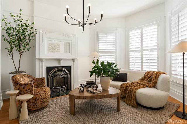 living area with wood-type flooring and a chandelier