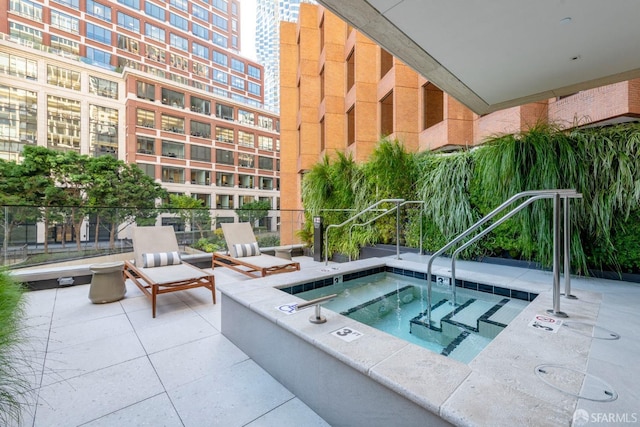 view of swimming pool with a community hot tub