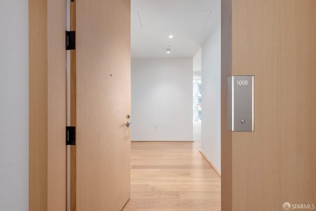 corridor with light hardwood / wood-style flooring