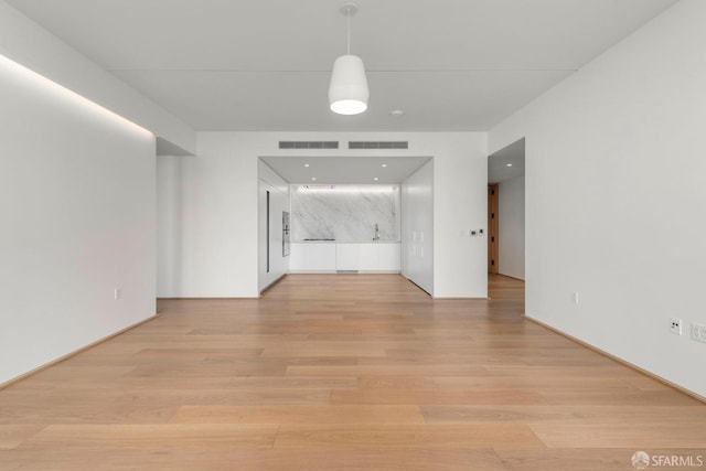 unfurnished living room with light wood-type flooring