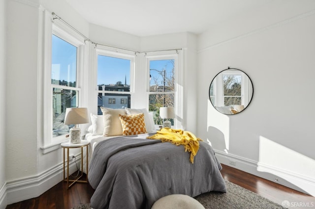 bedroom featuring dark wood-type flooring and baseboards