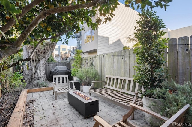 view of patio with an outdoor fire pit and a fenced backyard