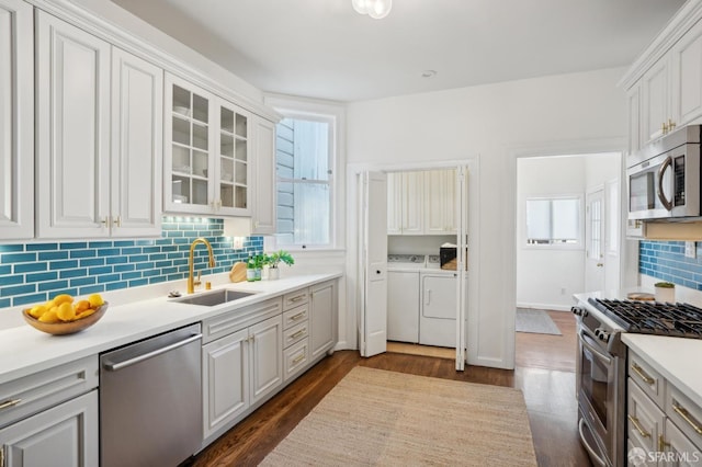 kitchen featuring glass insert cabinets, white cabinetry, appliances with stainless steel finishes, and light countertops