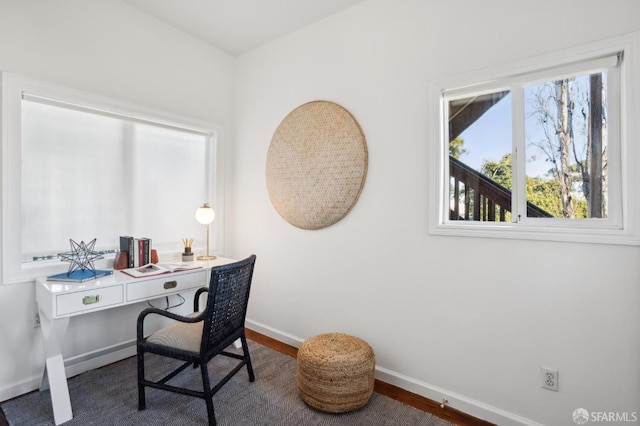 office space with baseboards and wood finished floors