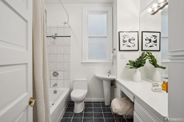 bathroom featuring baseboards, toilet, shower / bathtub combination with curtain, tile patterned flooring, and a sink