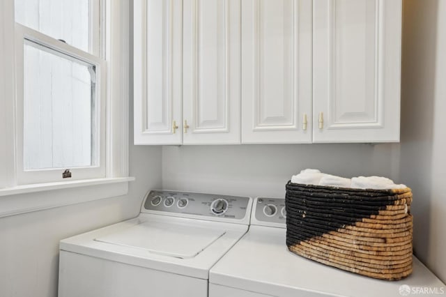 washroom with cabinet space and washing machine and clothes dryer