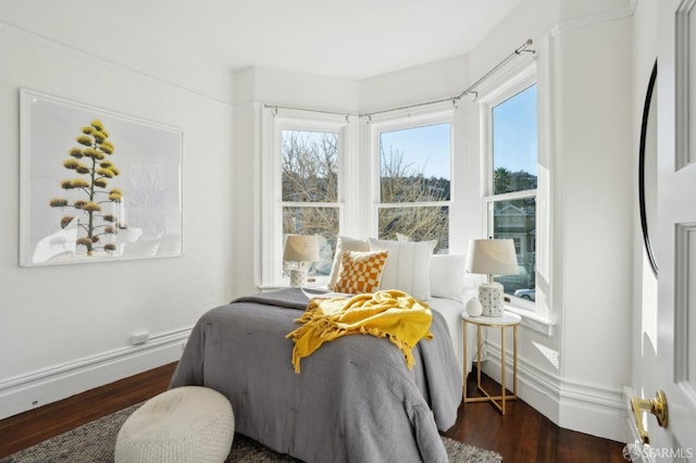 bedroom featuring dark wood-style floors and baseboards