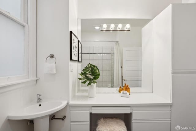 bathroom featuring a sink and a shower with shower curtain