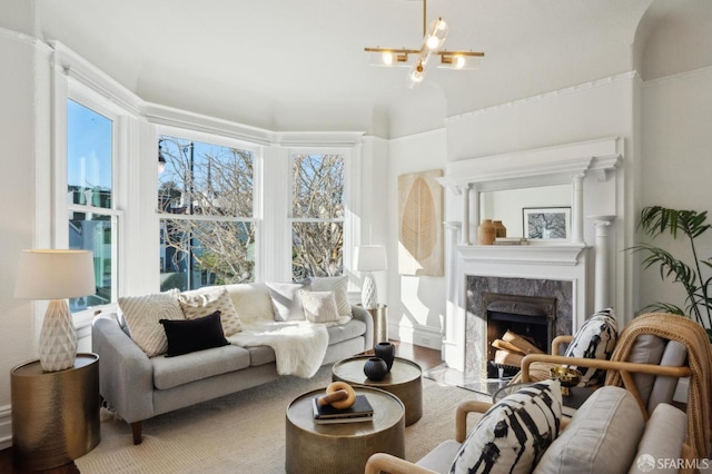 sunroom / solarium featuring an inviting chandelier and a high end fireplace