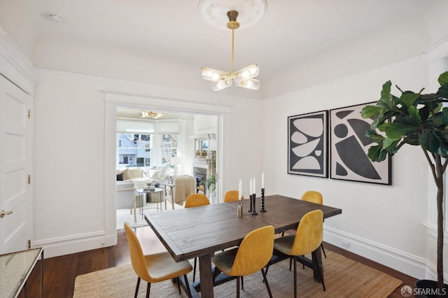 dining room with baseboards, dark wood-style flooring, and an inviting chandelier