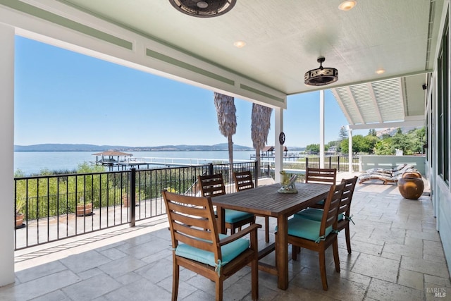 view of patio / terrace featuring ceiling fan and a water view