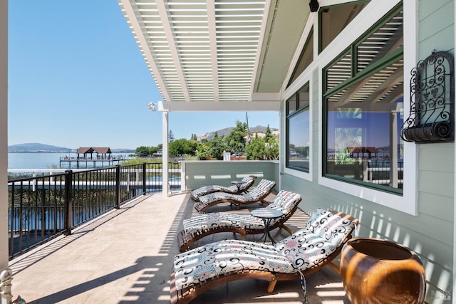 view of patio featuring a water and mountain view