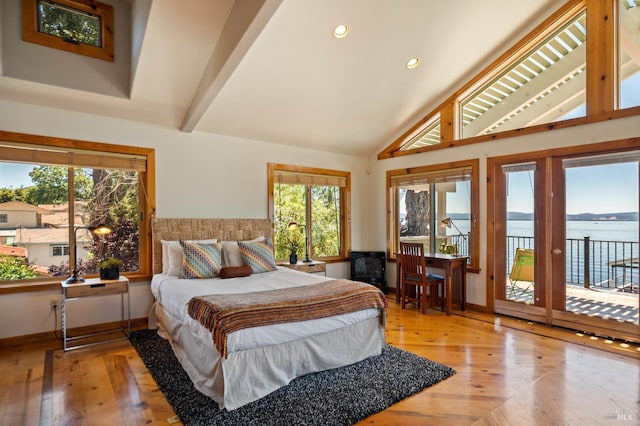 bedroom featuring access to exterior, light hardwood / wood-style flooring, vaulted ceiling with beams, and a water view