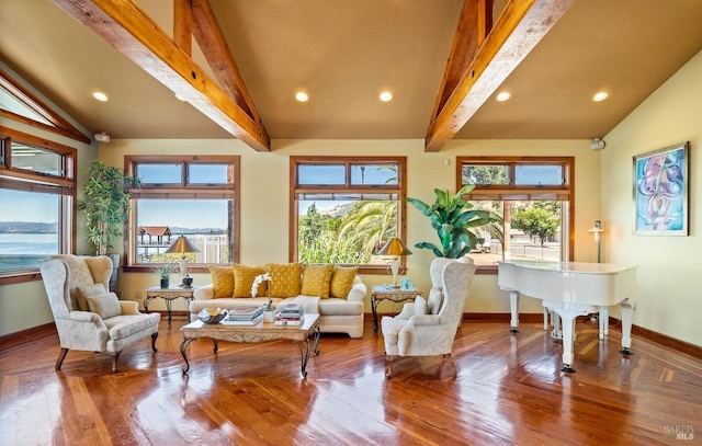 sunroom featuring vaulted ceiling with beams