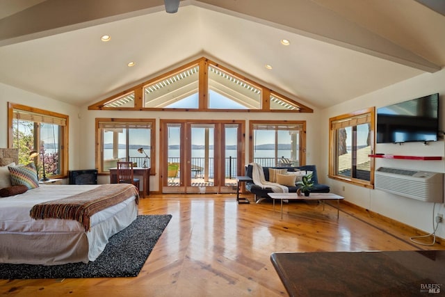 bedroom with lofted ceiling with beams, a wall mounted AC, and light hardwood / wood-style floors