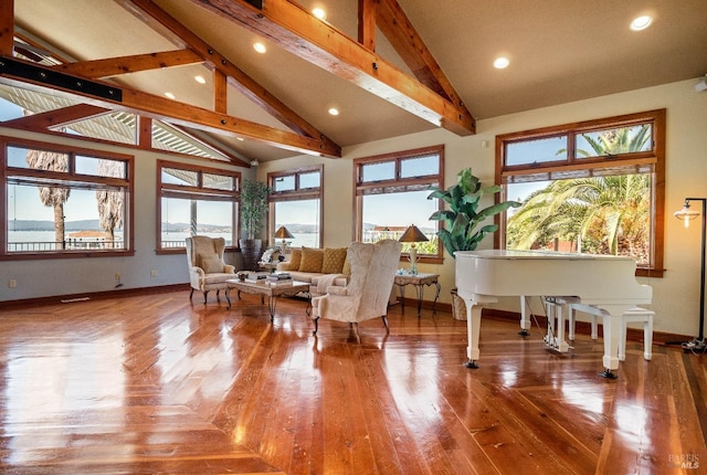 sitting room with high vaulted ceiling, a healthy amount of sunlight, and beam ceiling