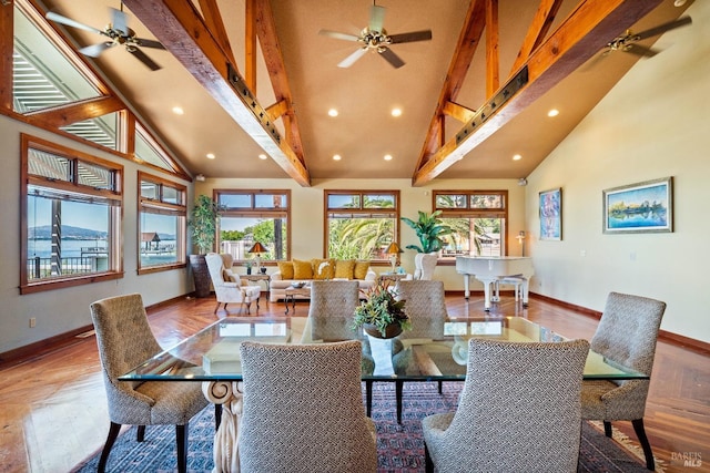 dining room with ceiling fan, wood-type flooring, beam ceiling, and high vaulted ceiling