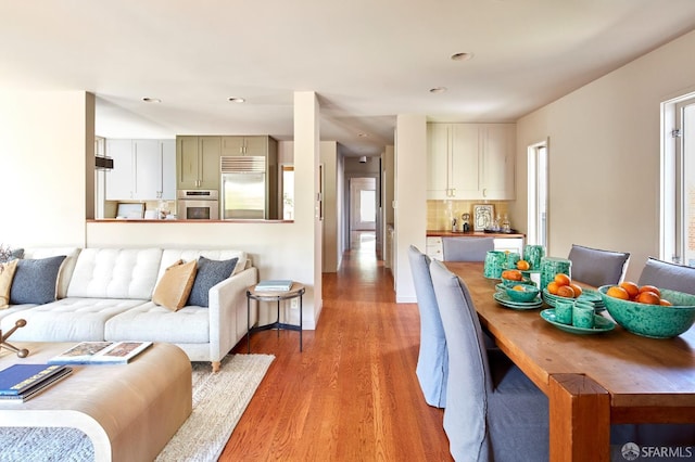 living room with recessed lighting and light wood-style flooring