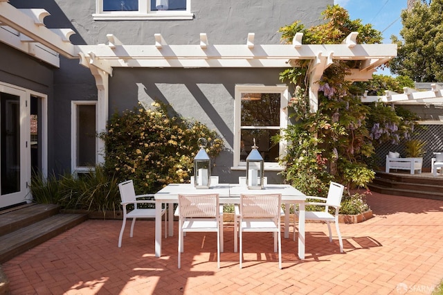 view of patio featuring entry steps, a pergola, and outdoor dining area