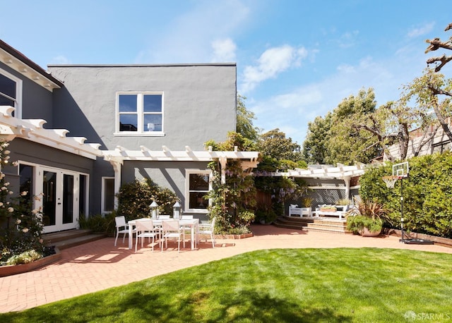 back of property featuring a pergola, stucco siding, french doors, a patio area, and a lawn