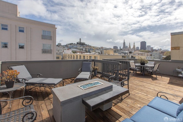 deck featuring a view of city and a fire pit