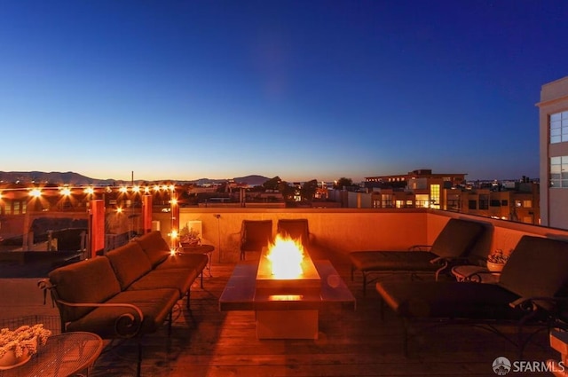 view of patio / terrace with an outdoor living space with a fire pit